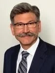 John E. Kusturiss Jr.
